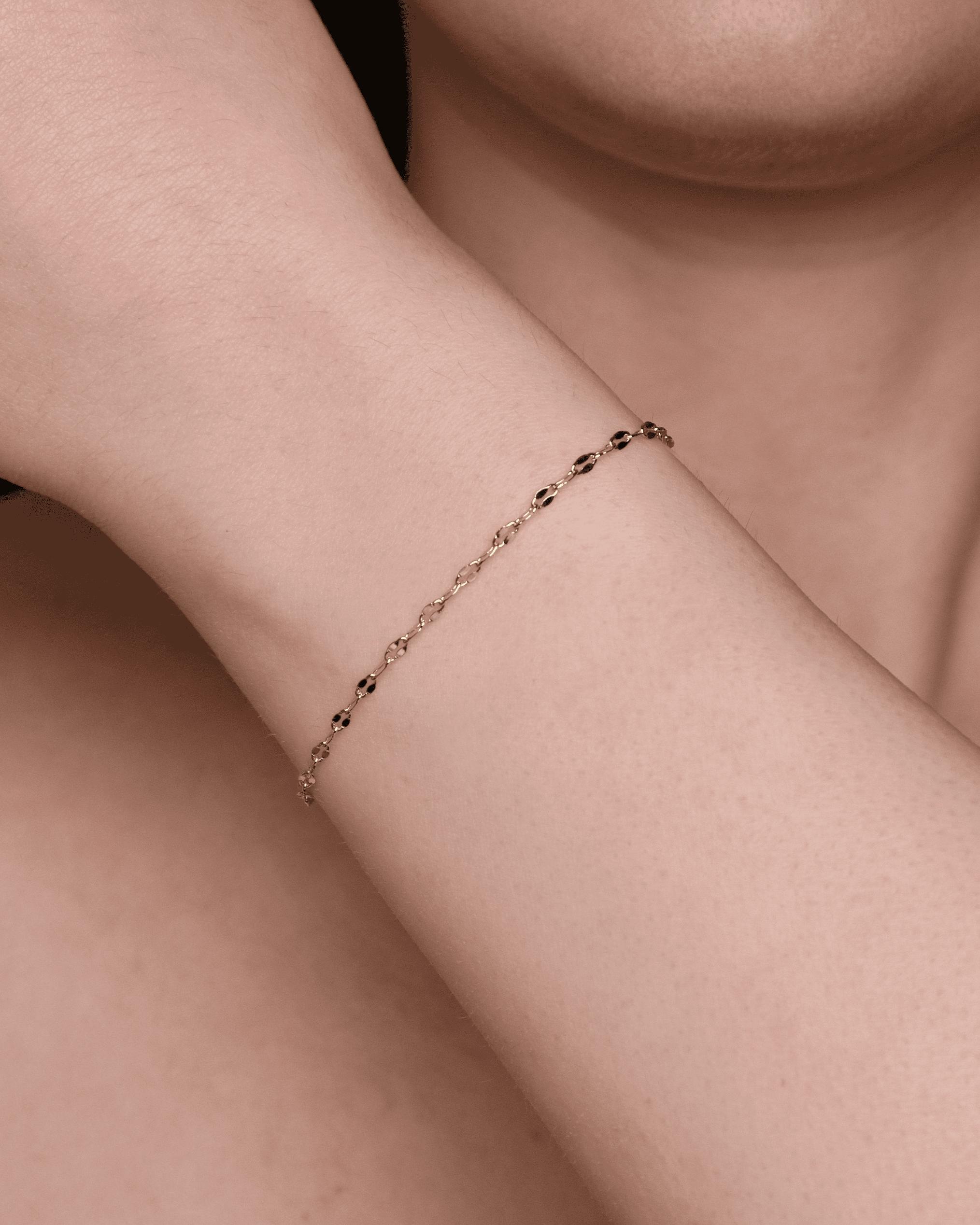 Bracciale elegante in oro con perline nere.